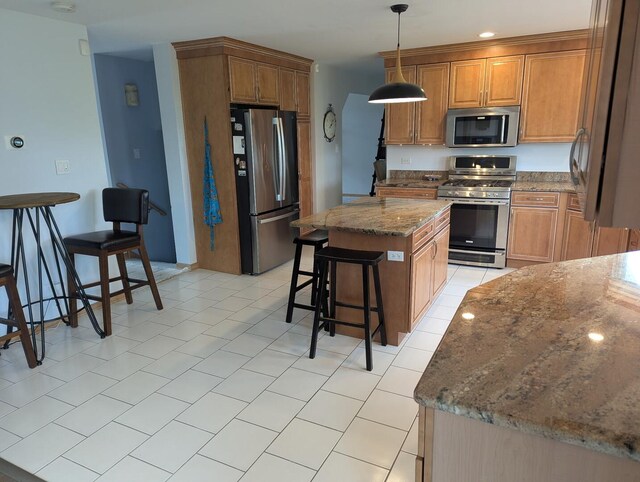1372 Pheasant Chase Cir, Beecher, IL 60401 - kitchen with appliances with stainless steel finishes, a breakfast bar area, a center island, brown cabinetry, and stone countertops