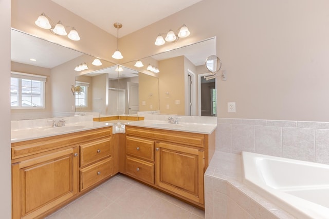 bathroom featuring tile patterned flooring, a garden tub, and double vanity