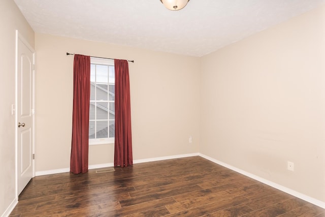 empty room with wood finished floors and baseboards