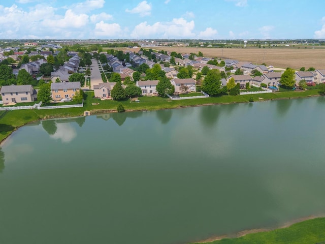 aerial view of property's location with nearby suburban area and a nearby body of water