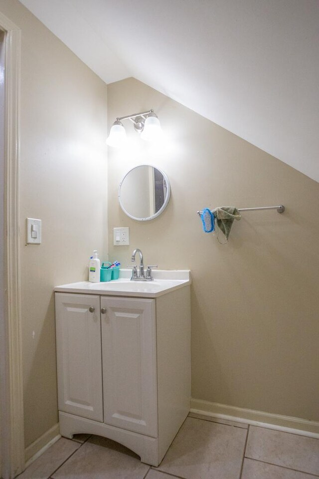 9226 S Ellis Ave, Chicago, IL 60619 - bathroom featuring vaulted ceiling, tile patterned flooring, vanity, and baseboards