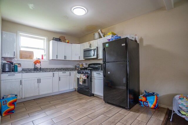 9226 S Ellis Ave, Chicago, IL 60619 - kitchen with black appliances, light wood-style flooring, white cabinets, decorative backsplash, and stone countertops