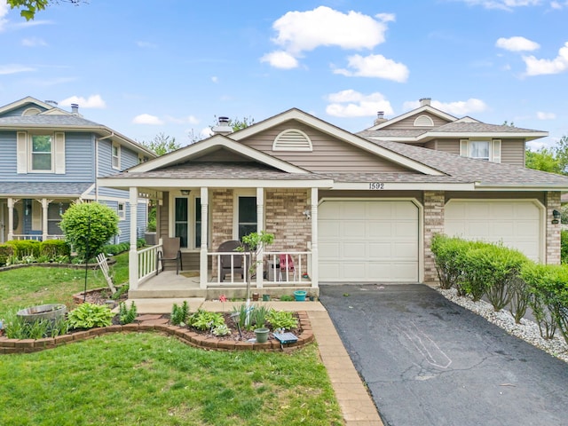 1592 Lighthouse Dr, Naperville, IL 60565 - view of front of property with a porch, asphalt driveway, a garage, a front yard, and a shingled roof