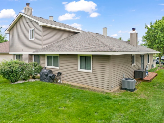 1592 Lighthouse Dr, Naperville, IL 60565 - back of property with cooling unit, a lawn, a chimney, and a shingled roof