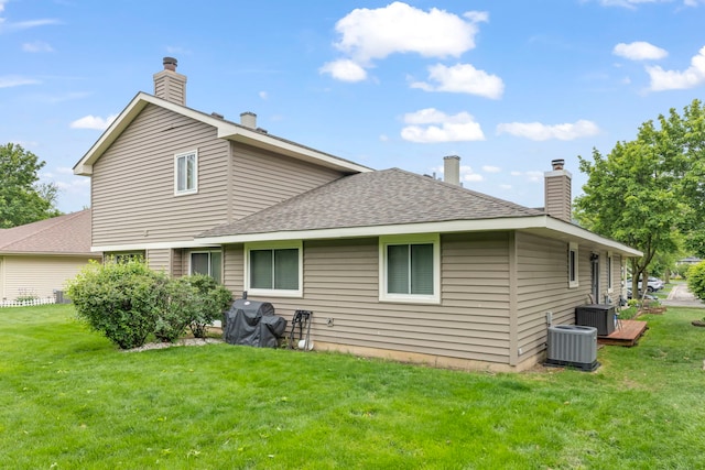 1592 Lighthouse Dr, Naperville, IL 60565 - back of house with a yard, central air condition unit, and a chimney