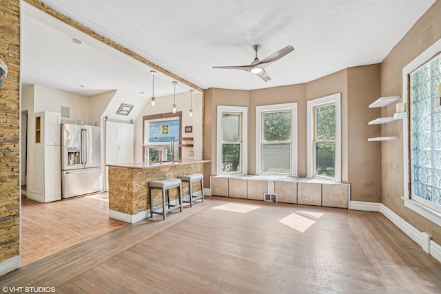 827 Lewis St, Dekalb, IL 60115 - kitchen featuring high quality fridge, light wood-type flooring, plenty of natural light, and a ceiling fan