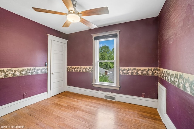827 Lewis St, Dekalb, IL 60115 - unfurnished room featuring wood finished floors, a ceiling fan, and baseboards