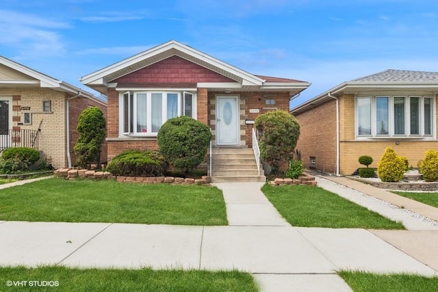 view of front of house with a front lawn and brick siding