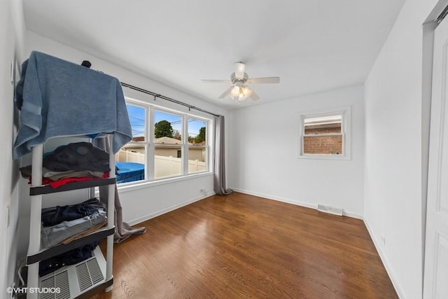 bedroom with wood finished floors, baseboards, and ceiling fan