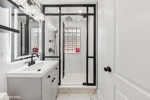 full bathroom featuring marble look tiles, a shower stall, vanity, and baseboards