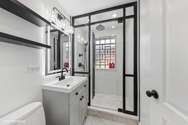 full bathroom with marble finish flooring, a shower stall, vanity, and toilet