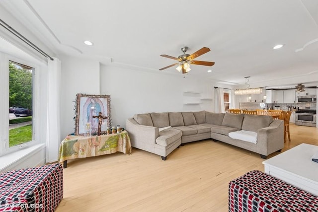 living room with a ceiling fan, light wood-style flooring, and recessed lighting