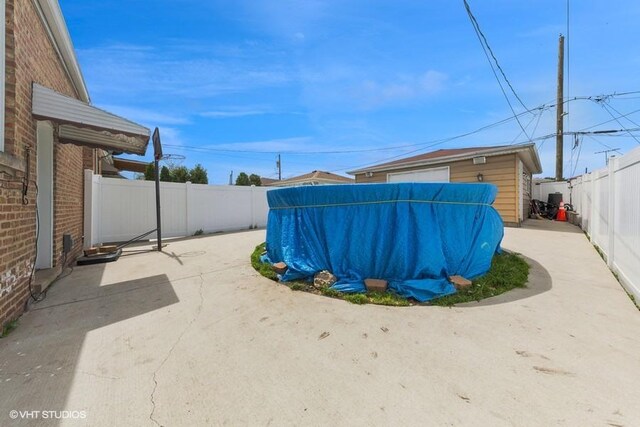fenced backyard with a patio area