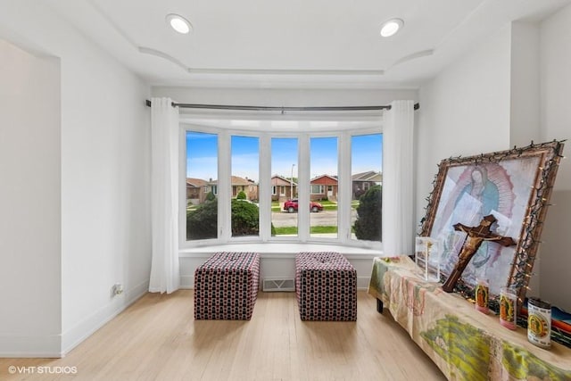 sitting room featuring light wood-style floors, baseboards, and recessed lighting