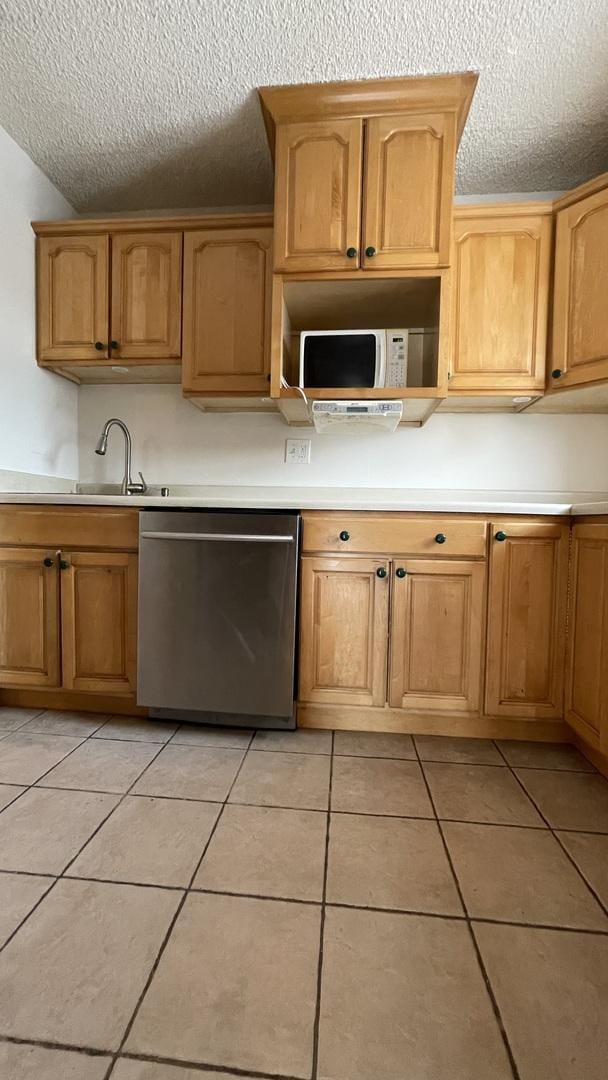 6221 N Niagara Ave Unit 401, Chicago, IL 60631 - kitchen featuring dishwasher, white microwave, a textured ceiling, light tile patterned flooring, and light countertops