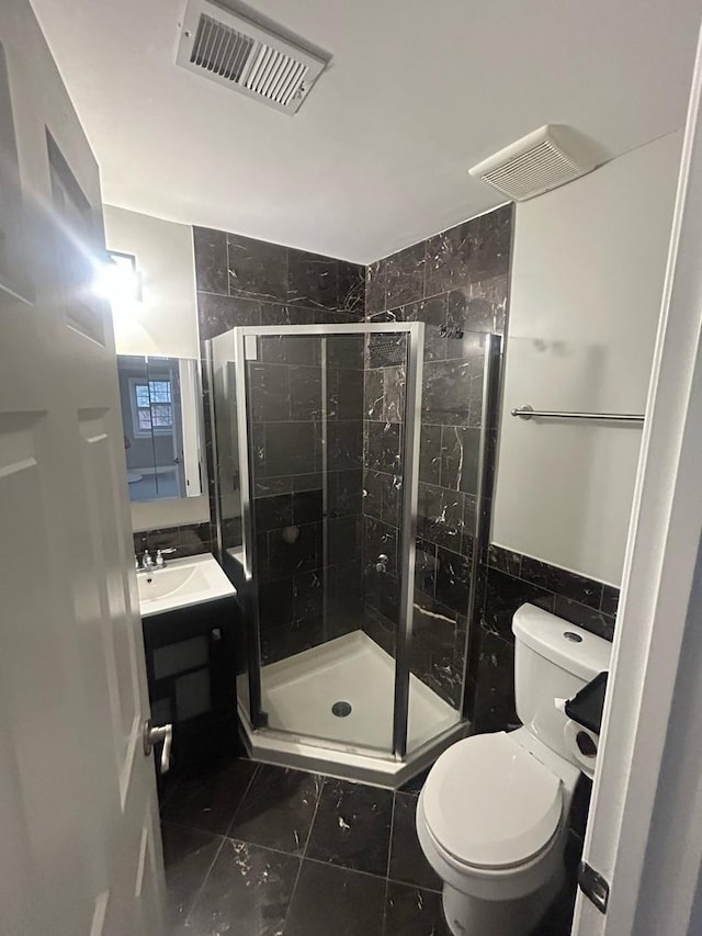 6135 W 94th St Unit C6, Oak Lawn, IL 60453 - bathroom with tile walls, a stall shower, marble look tiles, vanity, and toilet