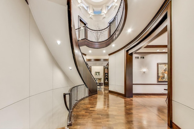 6535 N Tower Circle Dr, Lincolnwood, IL 60712 - stairway with wood finished floors, a high ceiling, and baseboards