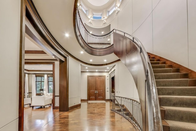6535 N Tower Circle Dr, Lincolnwood, IL 60712 - staircase featuring a towering ceiling, wood finished floors, ornamental molding, baseboards, and recessed lighting