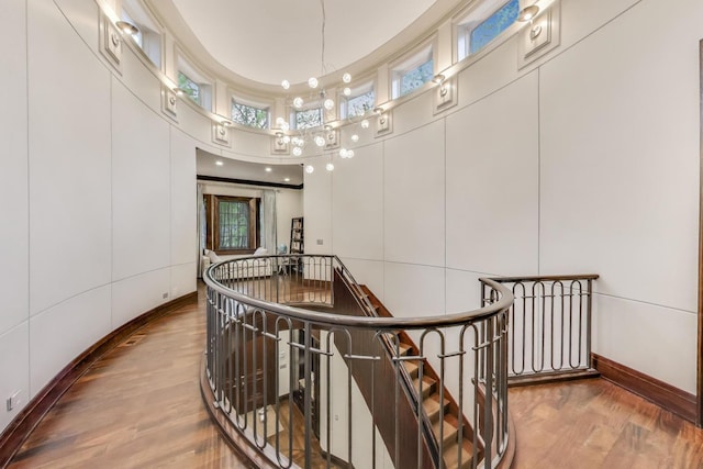 6535 N Tower Circle Dr, Lincolnwood, IL 60712 - hallway featuring an upstairs landing, wood finished floors, a high ceiling, and baseboards