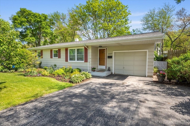 ranch-style house with asphalt driveway and a garage