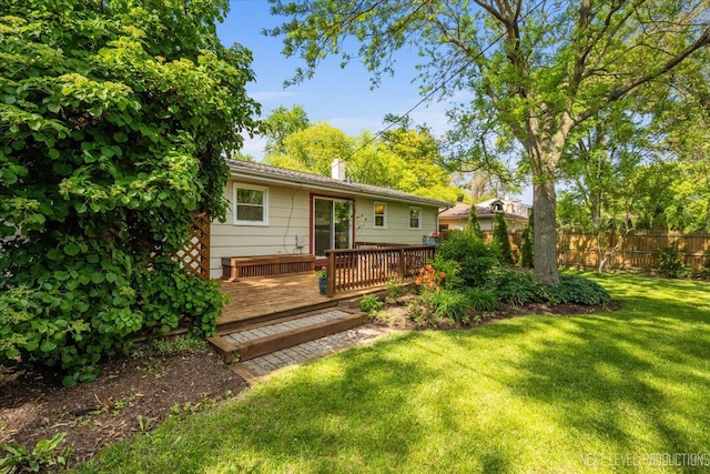 rear view of property featuring a wooden deck and a chimney