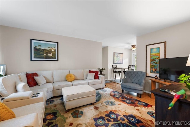 living room featuring wood finished floors and a ceiling fan