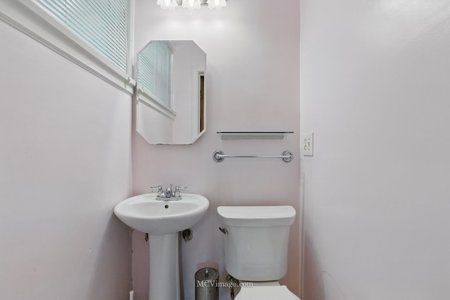 bathroom with toilet and a sink