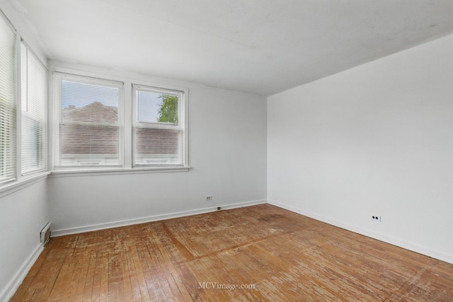 empty room with light wood-style flooring and baseboards