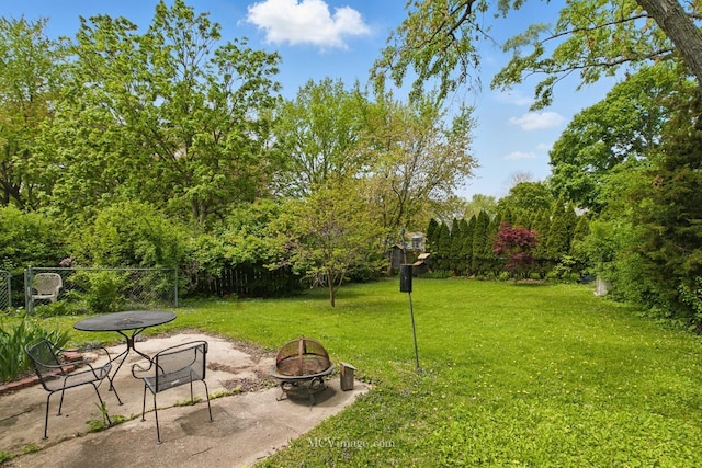 view of yard featuring an outdoor fire pit and a patio area