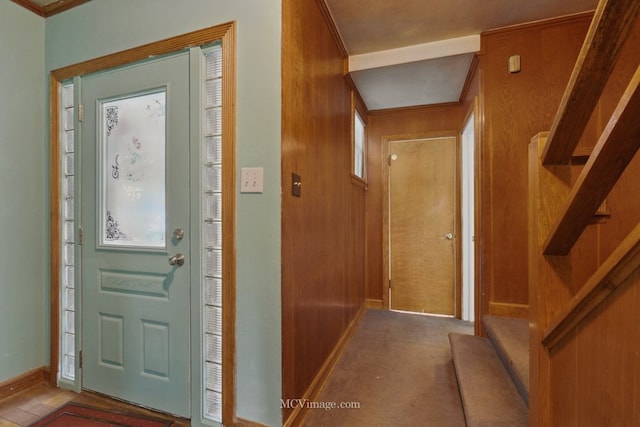 foyer featuring baseboards and stairway