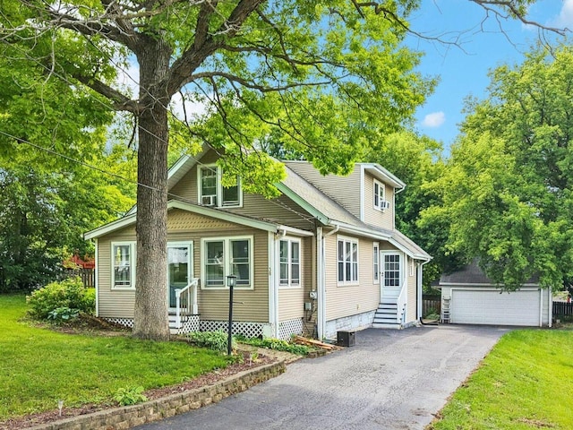 38 Highview Ave, Fox Lake, IL 60020 - view of front of house with entry steps, an outbuilding, a garage, and a front lawn