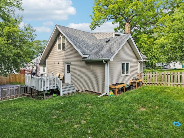 38 Highview Ave, Fox Lake, IL 60020 - rear view of house with a shingled roof, a deck, a fenced backyard, and a chimney
