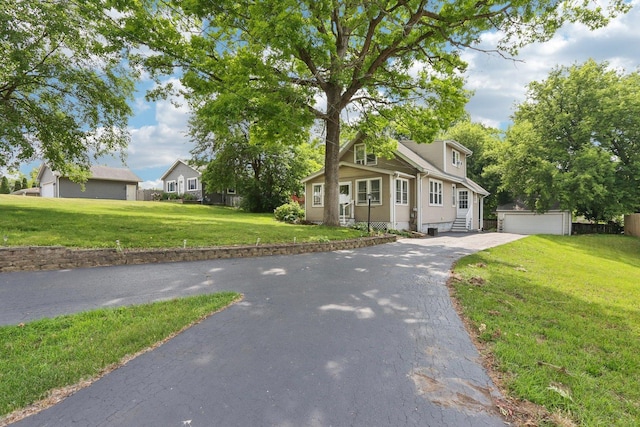 38 Highview Ave, Fox Lake, IL 60020 - view of front of house featuring an outbuilding, entry steps, a front lawn, and a garage