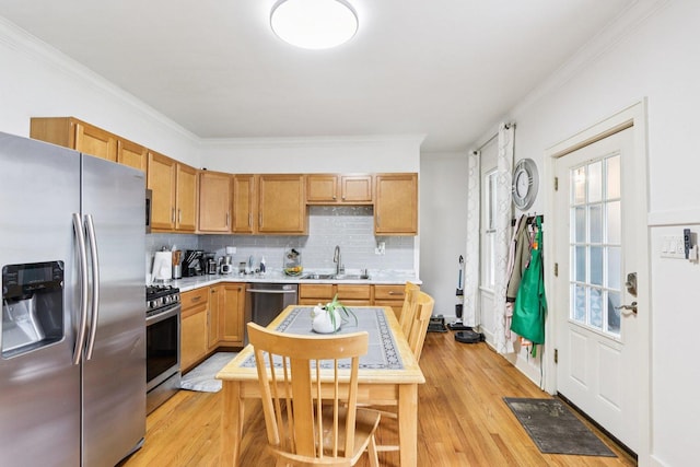 38 Highview Ave, Fox Lake, IL 60020 - kitchen featuring appliances with stainless steel finishes, light countertops, backsplash, ornamental molding, and light wood-style floors