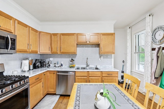 38 Highview Ave, Fox Lake, IL 60020 - kitchen with stainless steel appliances, light wood-style floors, light countertops, ornamental molding, and tasteful backsplash
