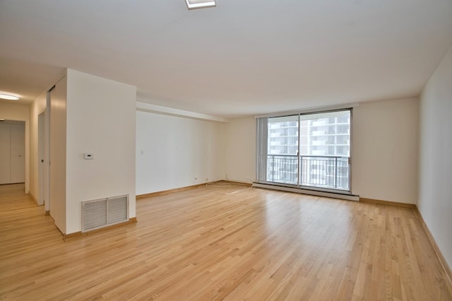 6007 N Sheridan Rd Unit 25F, Chicago, IL 60660 - unfurnished room featuring light wood-style flooring, baseboards, and baseboard heating