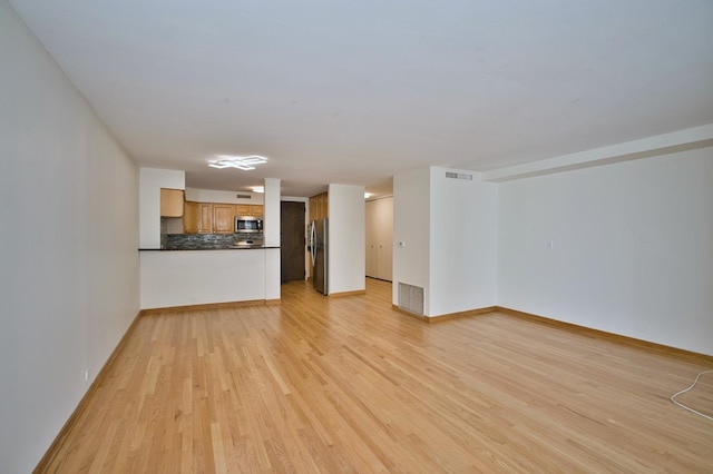 6007 N Sheridan Rd Unit 25F, Chicago, IL 60660 - unfurnished living room with light wood-style flooring and baseboards
