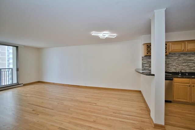 6007 N Sheridan Rd Unit 25F, Chicago, IL 60660 - unfurnished living room featuring light wood-style floors, a sink, baseboards, and baseboard heating