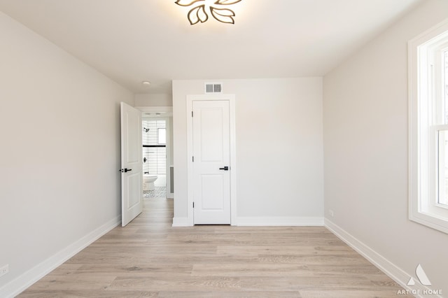 unfurnished bedroom featuring light wood-style floors and baseboards