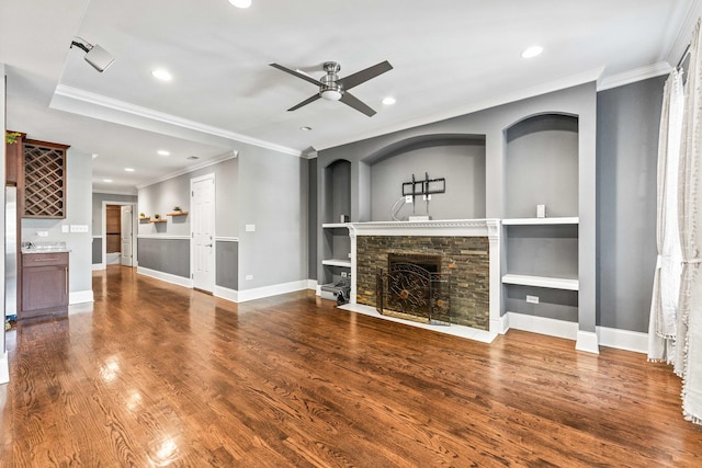 unfurnished living room featuring ceiling fan, a fireplace with flush hearth, recessed lighting, baseboards, and wood finished floors