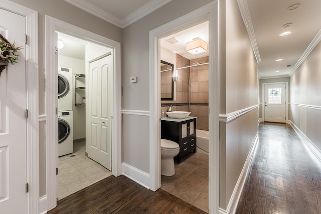 6337 N Magnolia Ave Unit 2, Chicago, IL 60660 - hall featuring stacked washer / drying machine, ornamental molding, wood finished floors, and recessed lighting