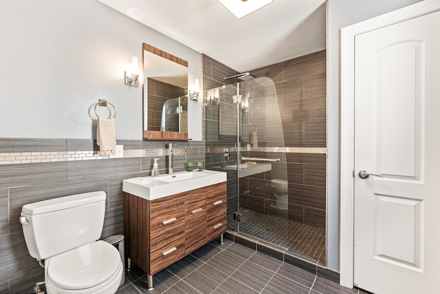 full bathroom with toilet, tile walls, a shower stall, and vanity