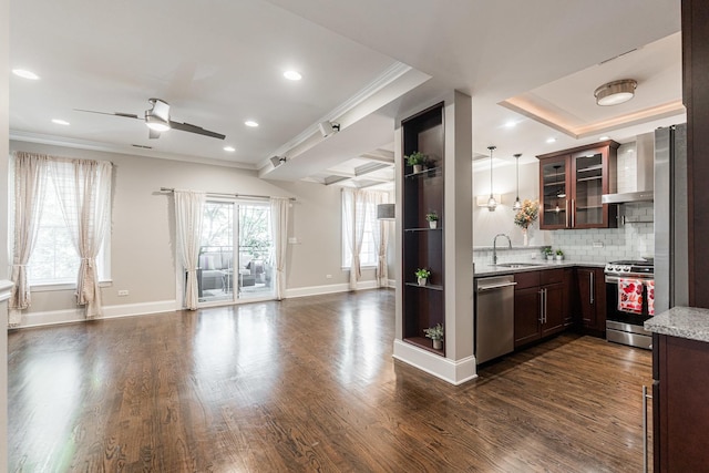 6337 N Magnolia Ave Unit 2, Chicago, IL 60660 - kitchen featuring appliances with stainless steel finishes, open floor plan, wall chimney exhaust hood, crown molding, and glass insert cabinets