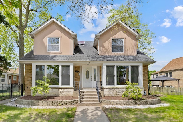 7810 Kildare Ave, Skokie, IL 60076 - view of front of house with fence, stone siding, and a shingled roof