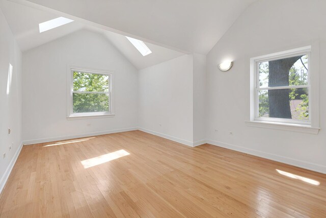 7810 Kildare Ave, Skokie, IL 60076 - additional living space with a skylight, lofted ceiling, plenty of natural light, light wood finished floors, and baseboards