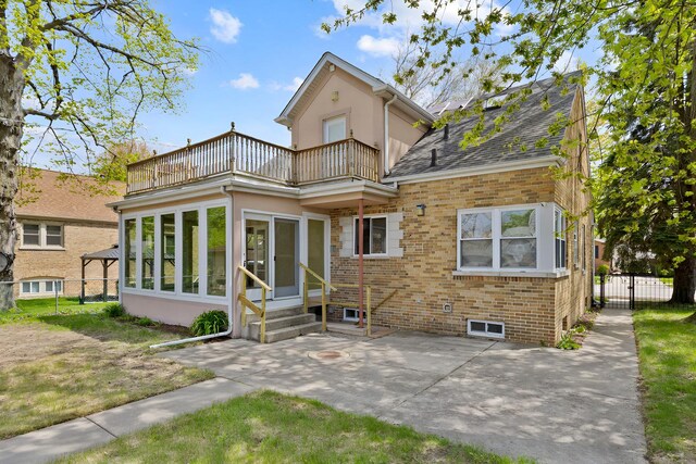 7810 Kildare Ave, Skokie, IL 60076 - back of property with a balcony, entry steps, a patio area, fence, and brick siding