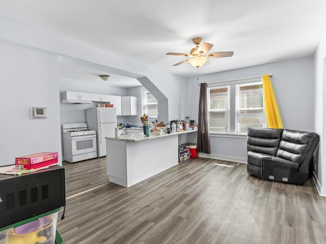 112 Webb St, Calumet City, IL 60409 - kitchen with white appliances, a peninsula, wood finished floors, white cabinets, and a ceiling fan