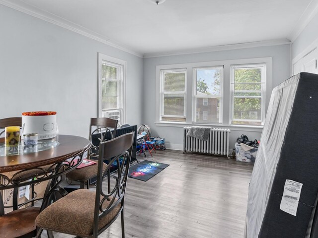 112 Webb St, Calumet City, IL 60409 - dining space featuring radiator heating unit, ornamental molding, wood finished floors, and baseboards