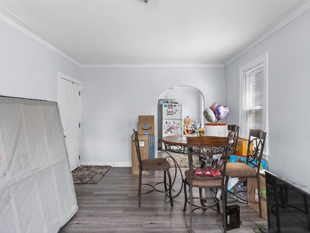 112 Webb St, Calumet City, IL 60409 - dining area featuring crown molding, wood finished floors, arched walkways, and baseboards
