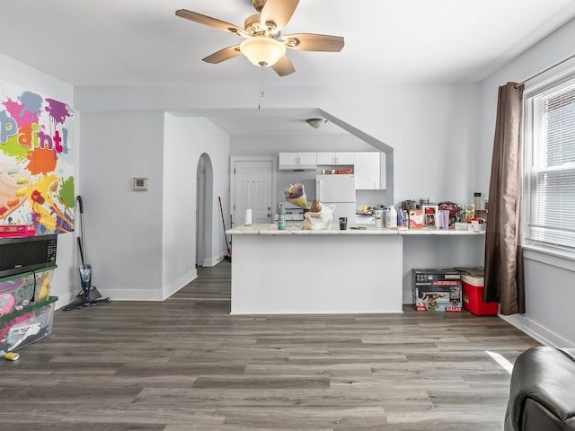 112 Webb St, Calumet City, IL 60409 - kitchen with freestanding refrigerator, arched walkways, white cabinetry, a peninsula, and ceiling fan